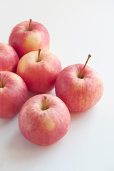 Close-up of red apples fresh and juicy on a white background. Fruit layout, vitamin food poster, apple peel details. Vertical with selective focus, copy space for text.