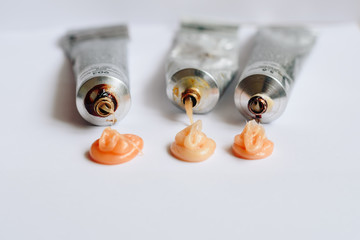 Squeezed out tubes of hair dye on a white background