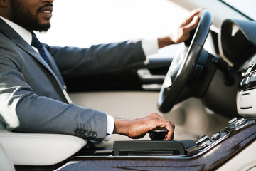 Unrecognizable Businessman Driving Car Sitting In New Luxury Automobile, Cropped