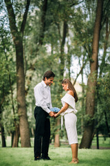 Bride And Groom In Love Holding Hands Standing In Park
