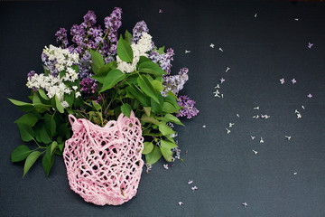 Eco bags with lilac flowers on dark background. Eco friendly concept. Copy space for your text