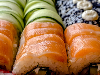 A close-up photography of a set of sushi rolls. Home delivery, Japanese cuisine.