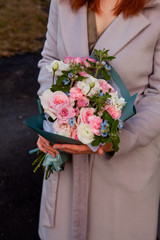 girl holding a beautiful wedding or gift bouquet in pink