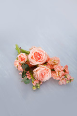 pink roses against the background of a vintage blue stool
