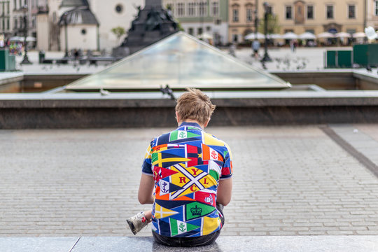 Man In A Colorful Polo Sitting On The Bench