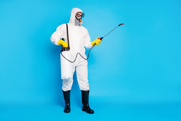 Full length photo of medical worker man use sprayer equipment disinfect copyspace covid infection...