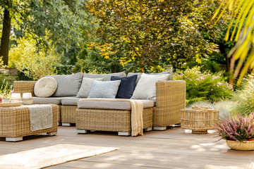 Beautiful summer day in elegant home garden with trendy furniture