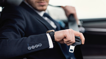 Guy Putting On Seat Belt Sitting In Car