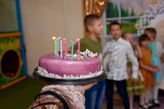 A Purple Birthday Cake Is Being Carried. Children's Holiday