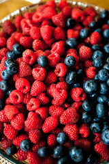raspberries and blueberries in plate