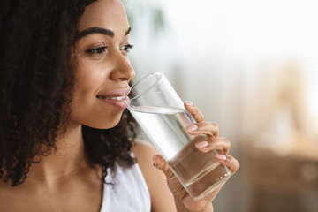 Healthy Liquid. Smiling Black Woman Drinking Water From Glass And Looking Away - obrazy, fototapety, plakaty