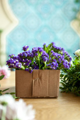 purple flowers in a carton