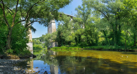 Beautiful summer landscape with a view of the river and a bridge over it near a tree in the city of Kamenetz-Podolsky
