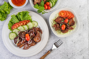 Fried pork topped with sesame placed in a white dish.