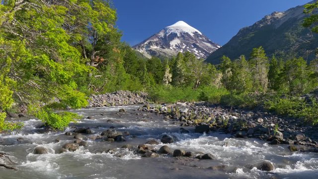 Lanin volcano in Lanin national park. Landscape with volcano, mountain river and green trees. Argentina, Patagonia, Lake district. 4k, UHD