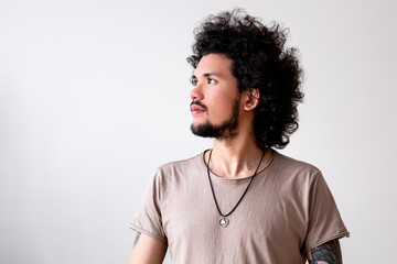 Latin American model slightly smiling, headshot, neutral background 