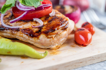 Chicken steak placed on a wooden tray.