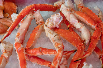 Fresh sea food crab legs on ice background