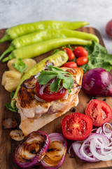 Chicken steak placed on a wooden tray.