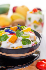 Fruit salad in a bowl on the wooden floor.