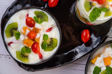 Fruit salad in a bowl on the wooden floor.