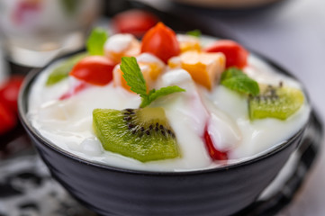 Fruit salad in a bowl on the wooden floor.