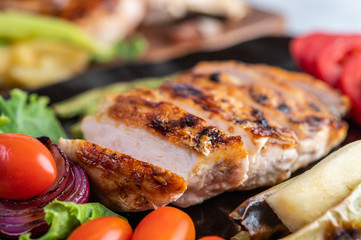 Chicken steak put on a black plate.
