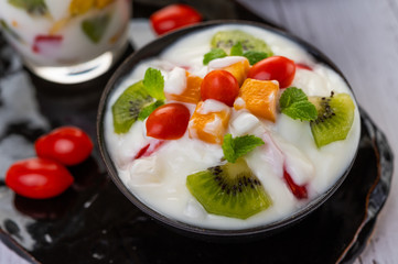 Fruit salad in a bowl on the wooden floor.
