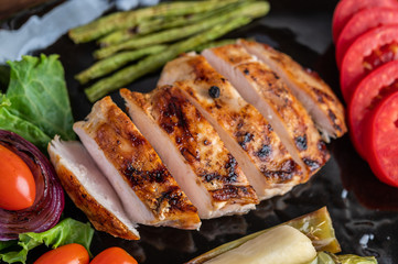 Chicken steak put on a black plate.