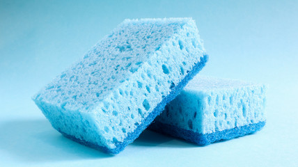 Two blue sponges used for washing and erasing dirt used by housewives in everyday life. They are made of porous material such as foam. Detergent retention, which allows you to spend it economically