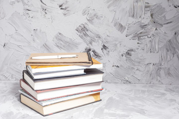 Stack of colorful books. An open book on a stack of books. The concept of education, international...