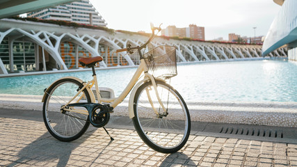 Fototapeta premium BEIGE AND BROWN BIKE IN WHITE MUSEUM AT THE SUNSET