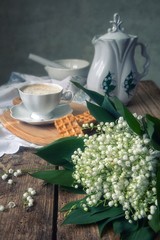  Cup of coffee and cookies with bouquet of spring flowers