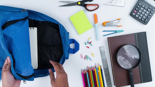 Student hands pack and unpack school supplies
