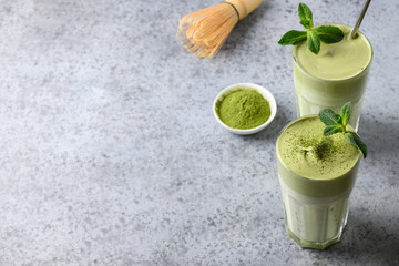Two glasses of Dalgona Matcha latte tea. Close up. Copy space.