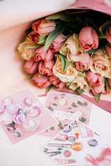 bouquet of pink and peach roses with cards for March 8