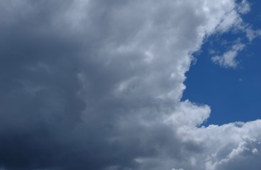 Intense grey cloudscape cover blue sky outside. Background, place for text