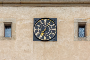 Antique round clock on the tower of Karlstejn Castle in the Czech Republic