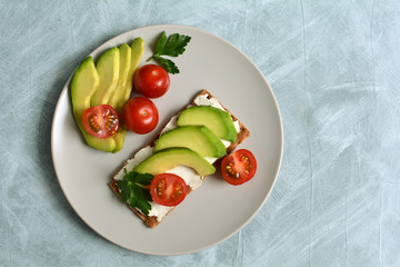 Vegetables tomatoes, avocado and greens for sandwiches