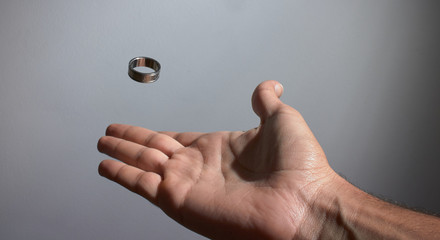 man's hand throwing ring in the air