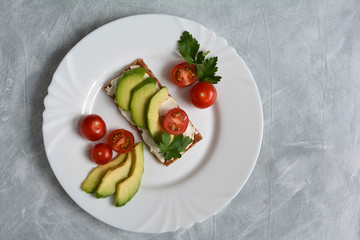 Vegetables tomatoes, avocado and greens for sandwiches