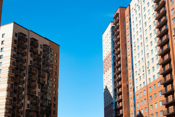 beautiful new brick multi-storey buildings on a background of blue sky