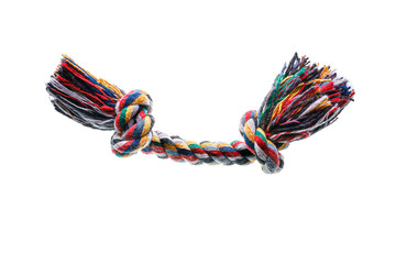 Pet toy, dog or puppy accessory, multicolored twisted soft threads with knots and tassels isolated on white background. Plaything for dental health and education.