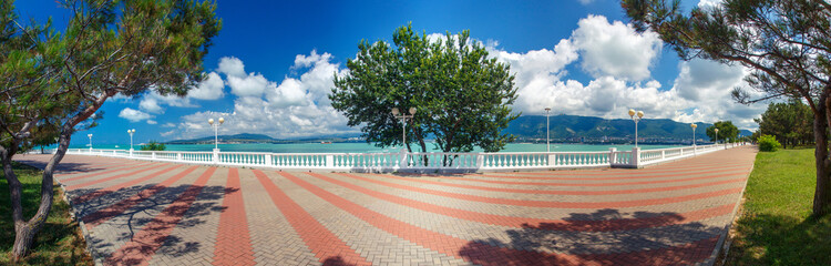 The embankment of the resort of Gelendzhik in clear Sunny weather. White balustrade and street lights. In the background Black Sea