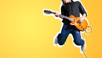 Male guitarist playing music and jump - obrazy, fototapety, plakaty