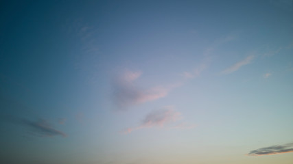 Clear,almost cloudless sky at sunset or sunrise with minimum of light strokes of clouds, with light...