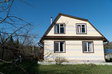 Obraz premium two-story summer house and garden in spring