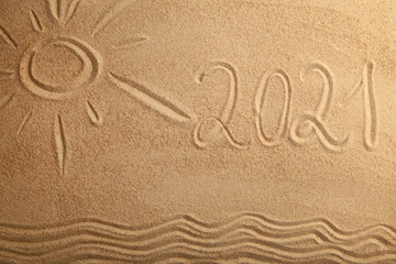 Fototapeta na wymiar 2021 new year text with sun on sand background