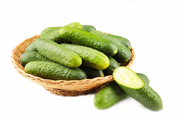 Fresh cucumbers in basket isolated on white background