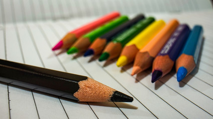 Naklejka premium colored pencils on black background